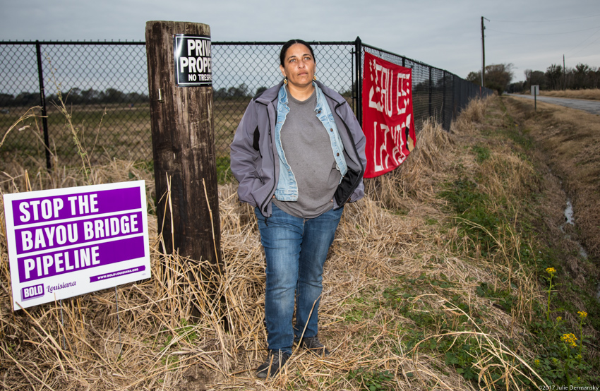 Louisiana activist Cherri Foytlin with anti-Bayou Bridge pipeline signs by land she bought that is in the pipeline's path