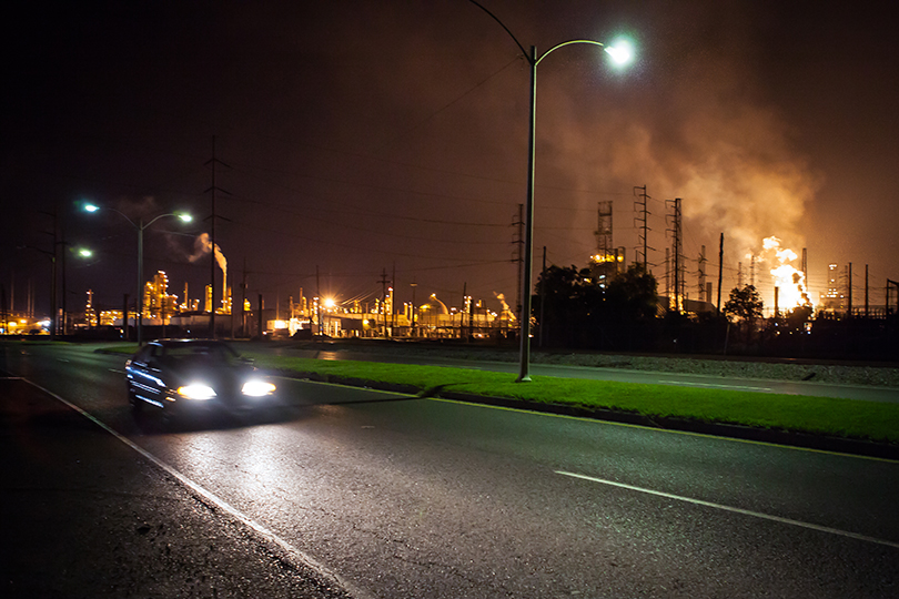 Car passing a flare at the Chalmette Refining plant in Chalmette, Louisiana.