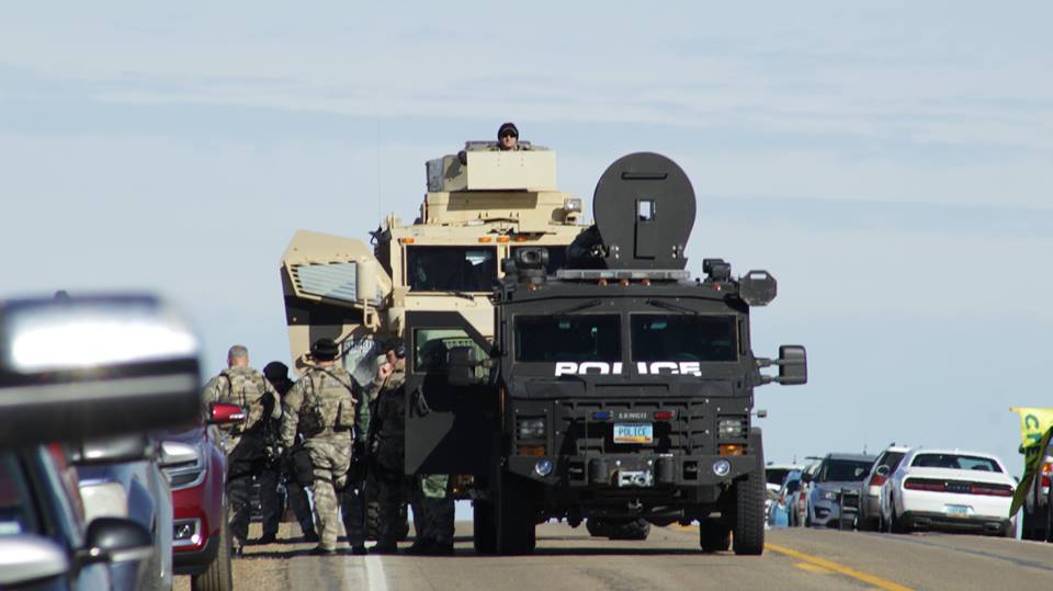 Officers in militarized vehicles at the protest.