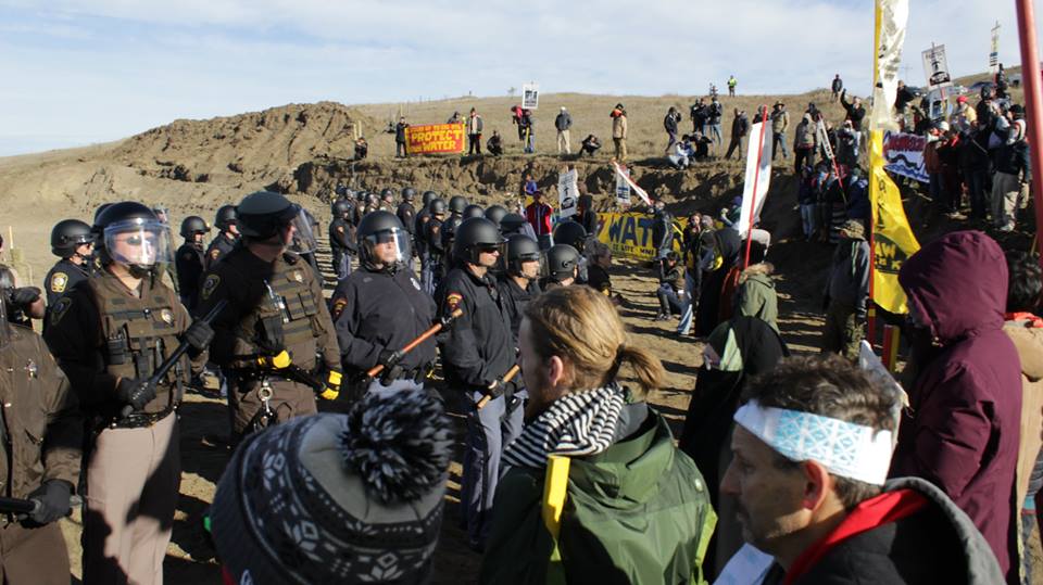 Law enforcement stands off with protesters at the site of the pipeline construction.