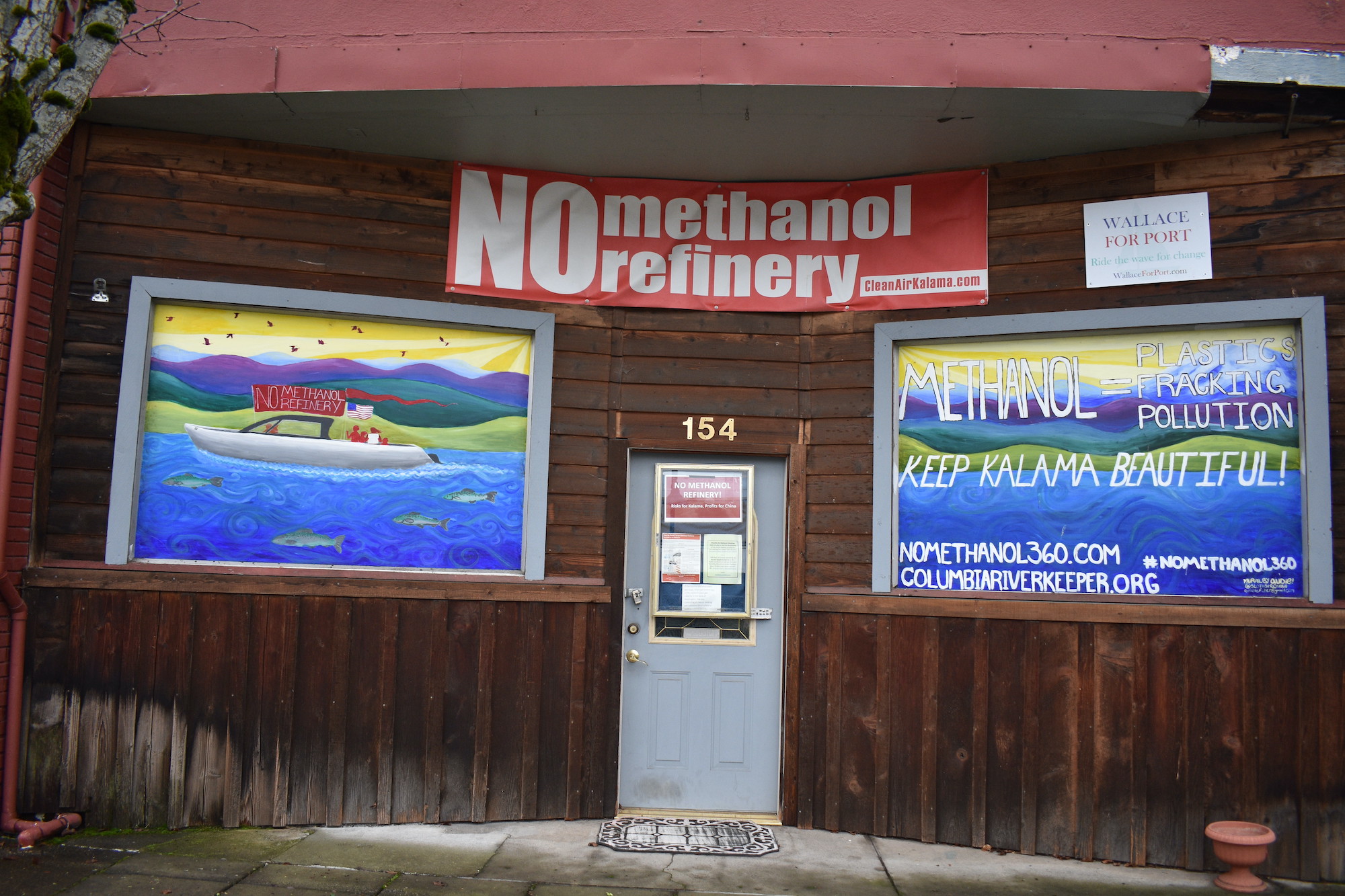 Building front displaying signs and artwork opposing NWIW's Kalama methanol refinery.