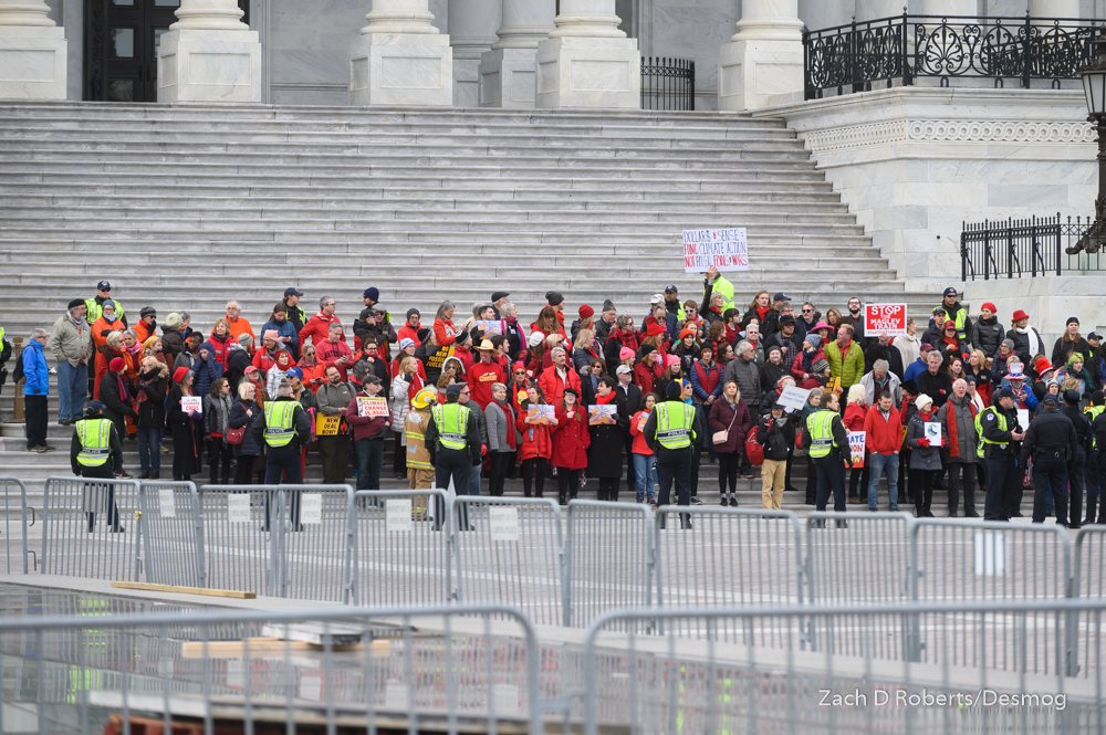 Crowd at bottom steps of US Capitol with police