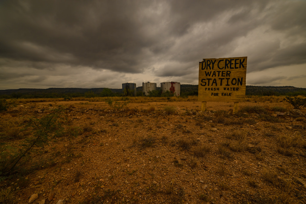 Dry Creek Water Station sign looking very dry outside Sanderson, Texas