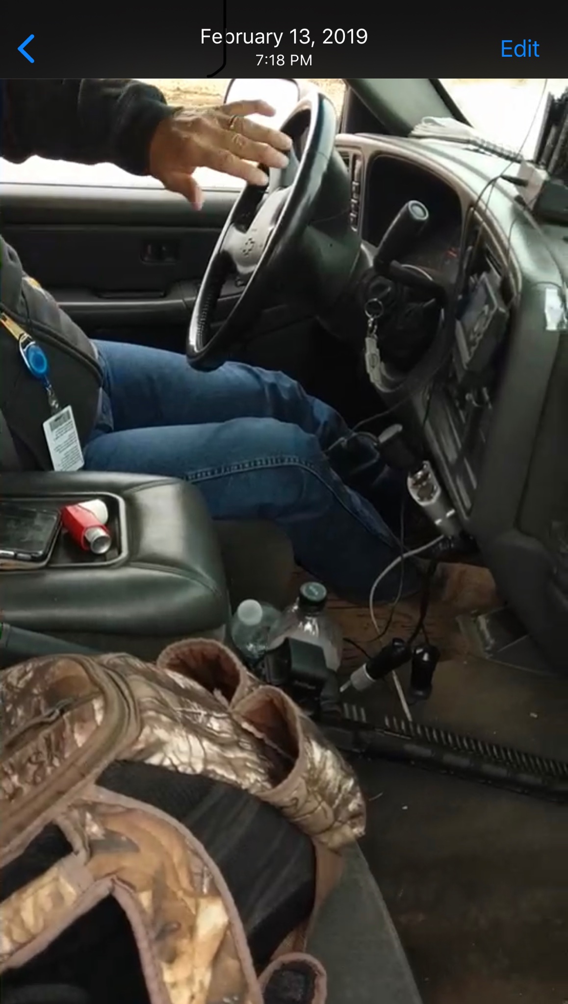 An oilfield security guard with a chambered 5.56 rifle in his company vehicle's front seat