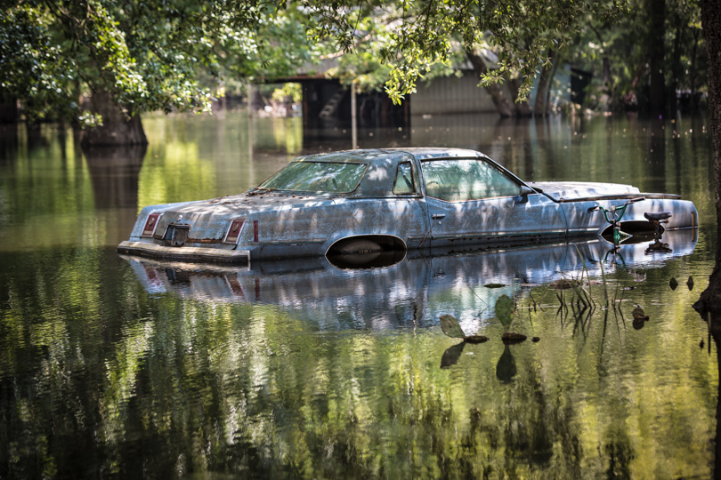 Car in flooded Louisiana neighborhood.