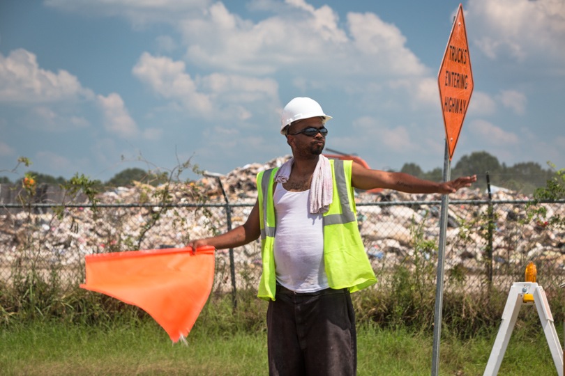 Naquille Everson directing traffic in front of the landfill on N. Sherwood Forest Drive near Monticello, Louisiana. 