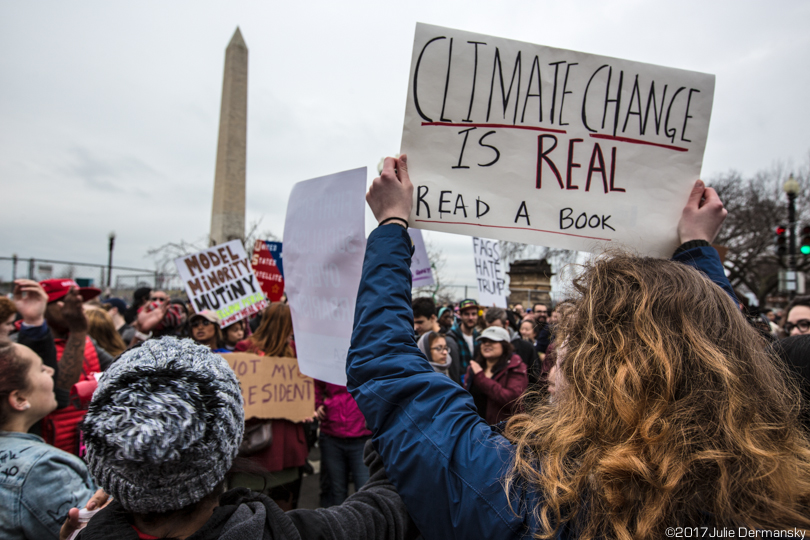 Protesters hold signs supporting climate science at Trump's inauguration