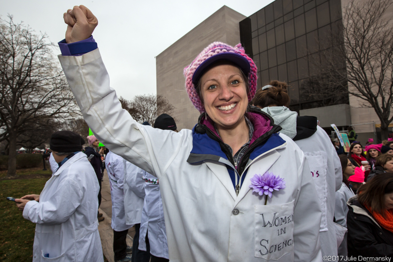 Scientist Christy Till in a lab coat at the Women's March.