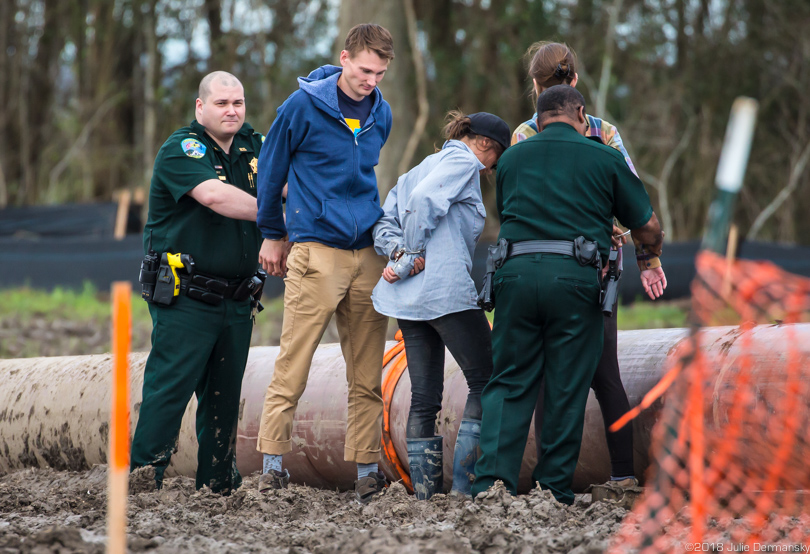 Three activists were arrested by police after refusing to get off a piece of pipeline during a Bayou Bridge protest