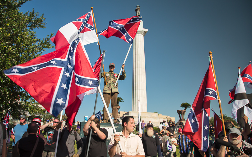 Protesters in Louisiana wave Confederate flags in front of a memorial 