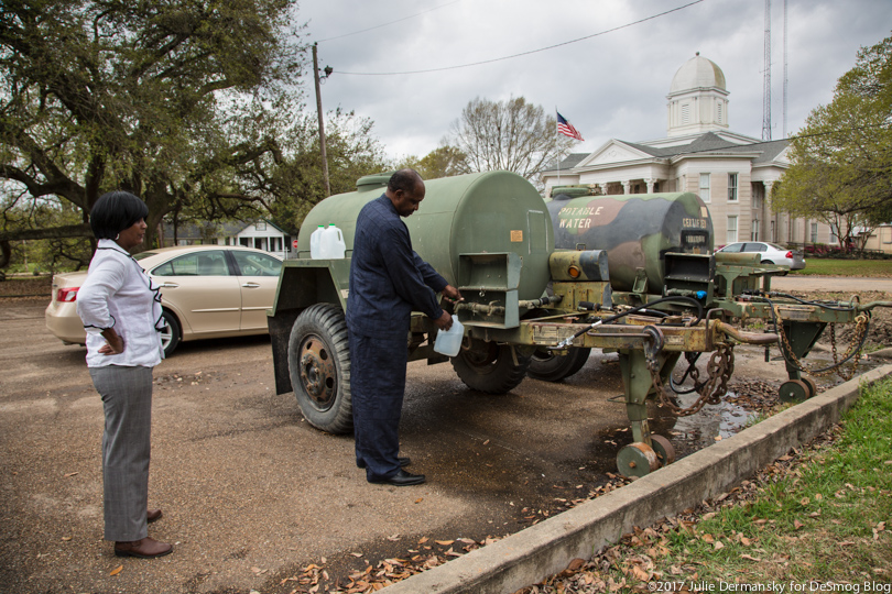 Roy and Wanda Bowman fill jugs with clean water from giant tanks