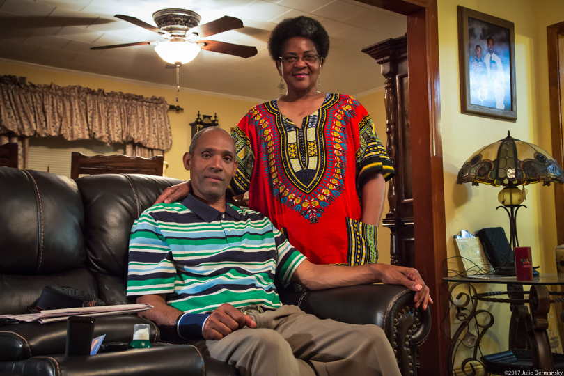 The Handy family sits in their home across from Denka's plant