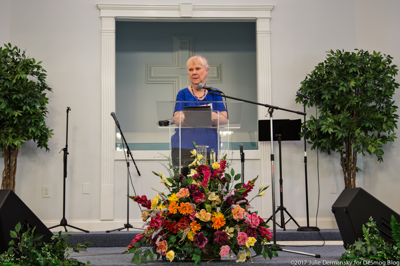 Wilma Subra speaking at a podium at a meeting of the Concerned Citizens of St. John the Baptist Parish