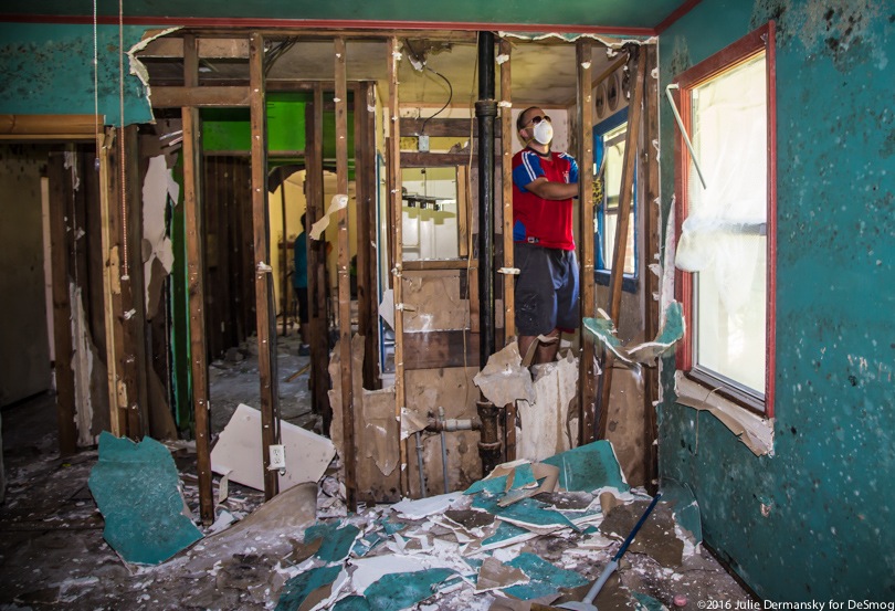 Workers gutting a flood-damaged house in Louisiana.