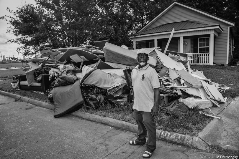 Port Arthur resident Percy Blacke in front of debris he removed from his home after Hurricane Harvey