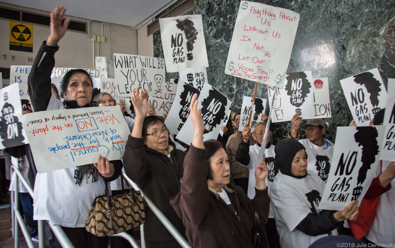 Vietnamese community members from New Orleans East hold signs and wait to enter New Orleans City Council meeting