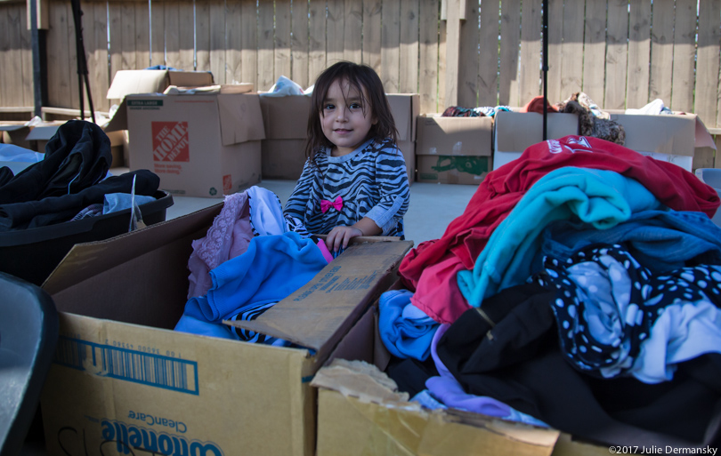 A child gathers donated supplies in Port Arthur