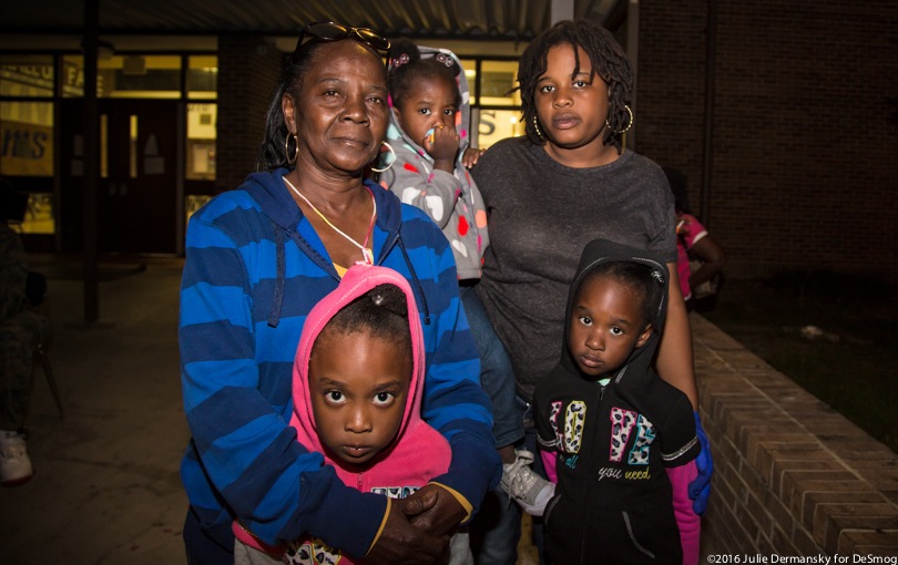 A family stands in an emergency shelter after Hurricane Matthew.