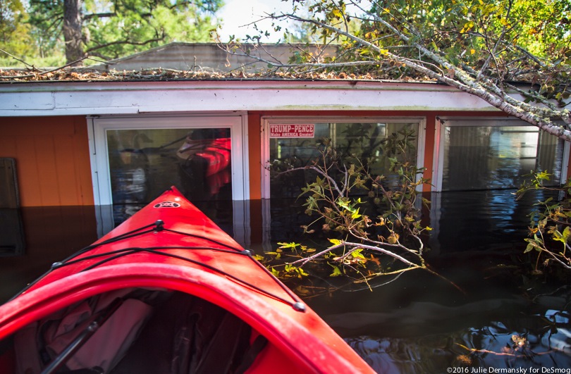 A kayak floating in front of flooded South Carolina home.