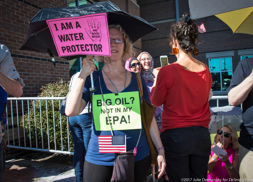 Protesters holding signs outside Sen. Cassidy's town hall