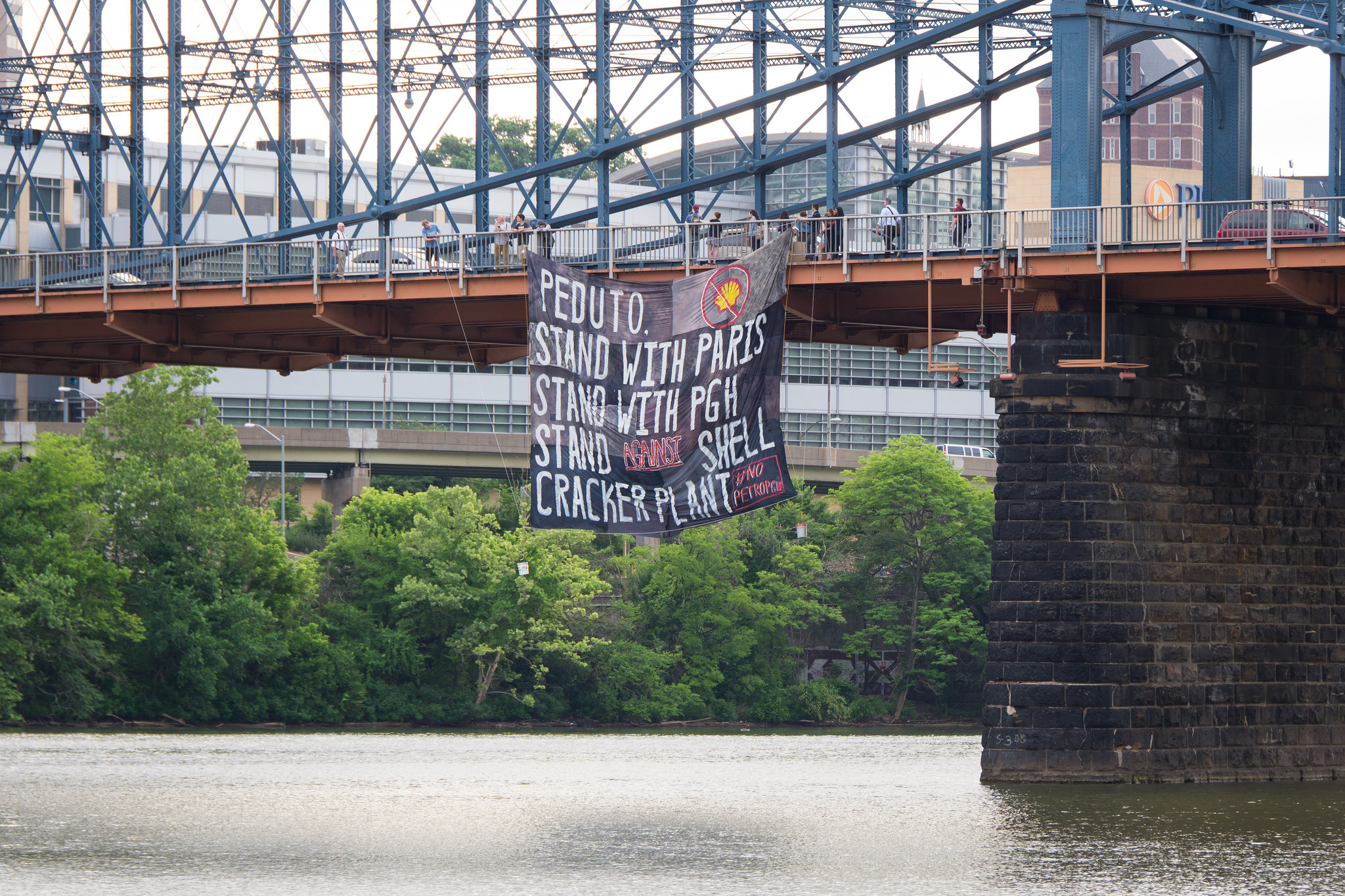 Banner against Shell ethane cracker plant on a bridge in Pittsburgh.