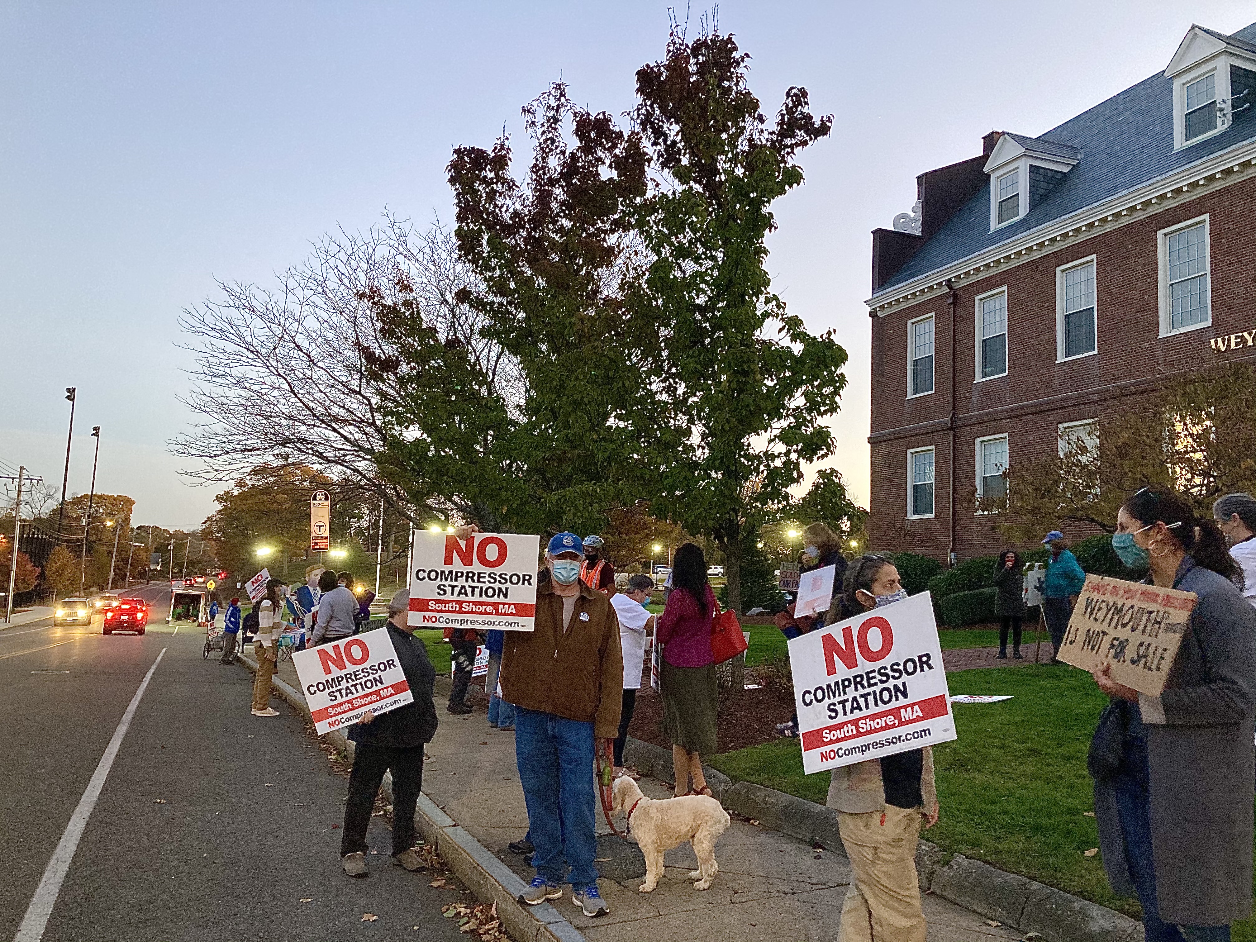 Rob McCarthy (center, blue hat) and other community members demonstrate outside Weymouth Town Hall on November 6, 2020. 