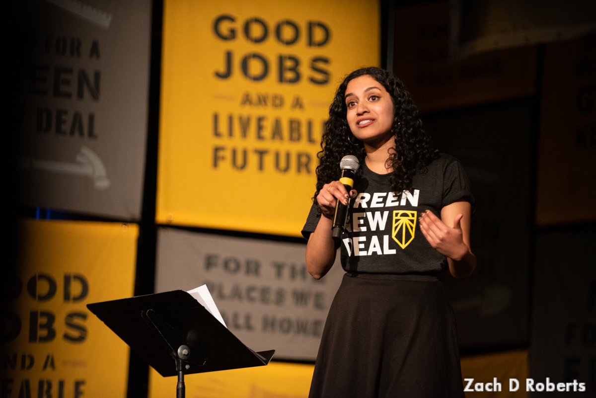 Varshini Prakash, cofounder of the Sunrise Movement, speaks on stage.