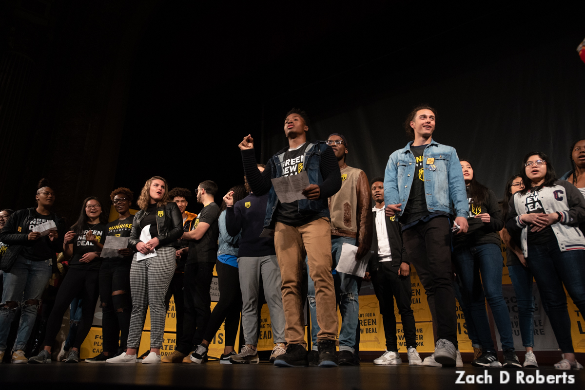 Local Sunrise Movement members sing on stage at the national Green New Deal tour launch.