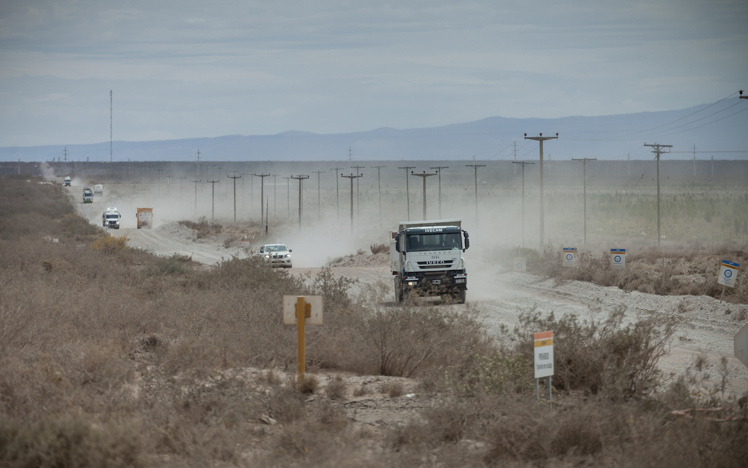 Convoys of trucks clog unpaved roads in the Vaca Muerta shale of Argentina