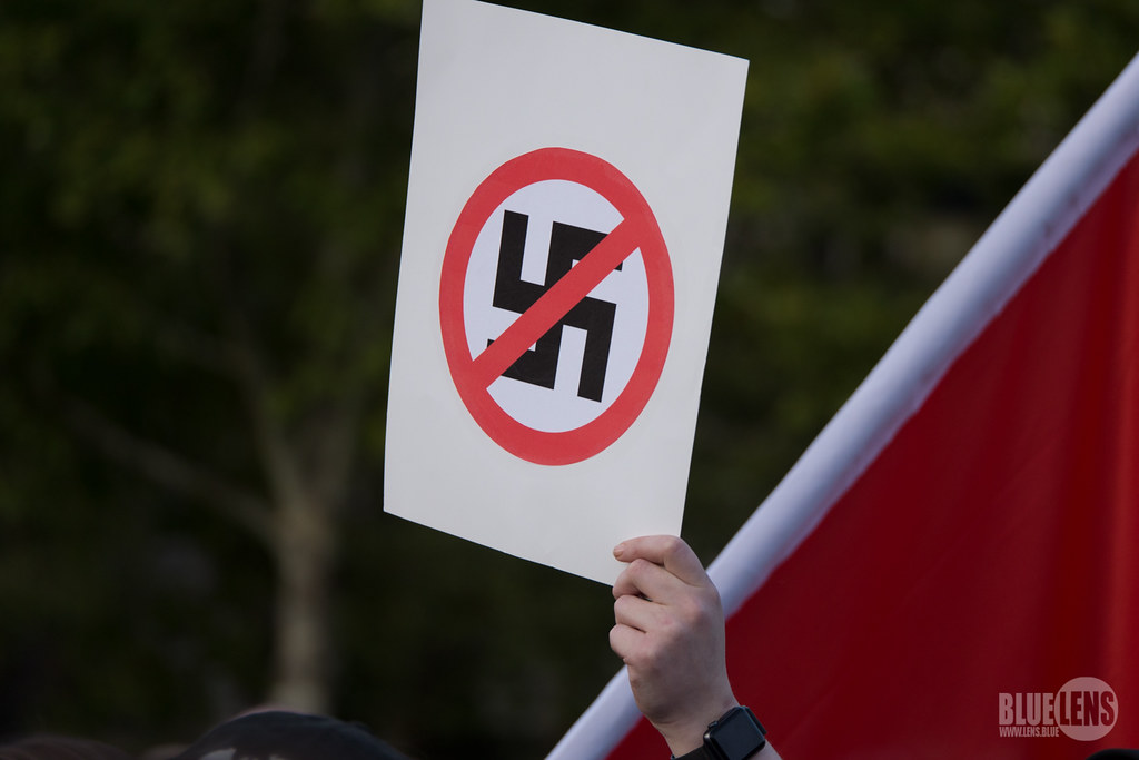 Someone holds an anti-swastika sign at a Charlottesville support rally in Pittsburgh in 2018.