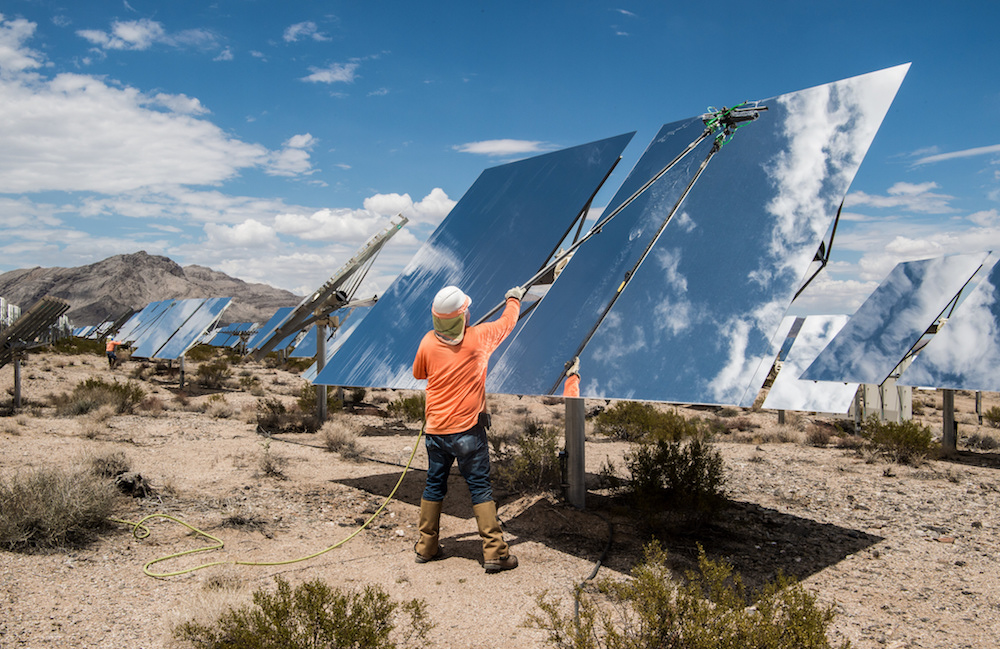 Worker cleaning mirrors in a concentrated solar plant