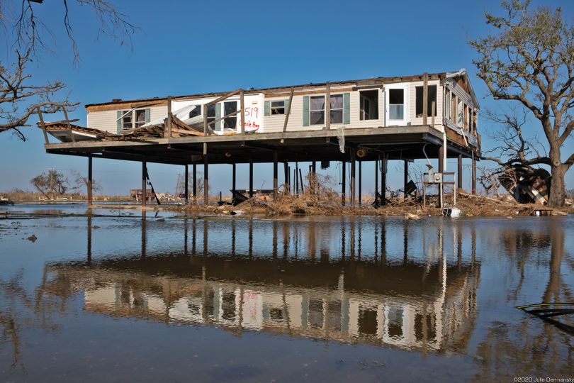 A damaged home in Creole, Louisiana, stands above floodwaters after Hurricane Delta.