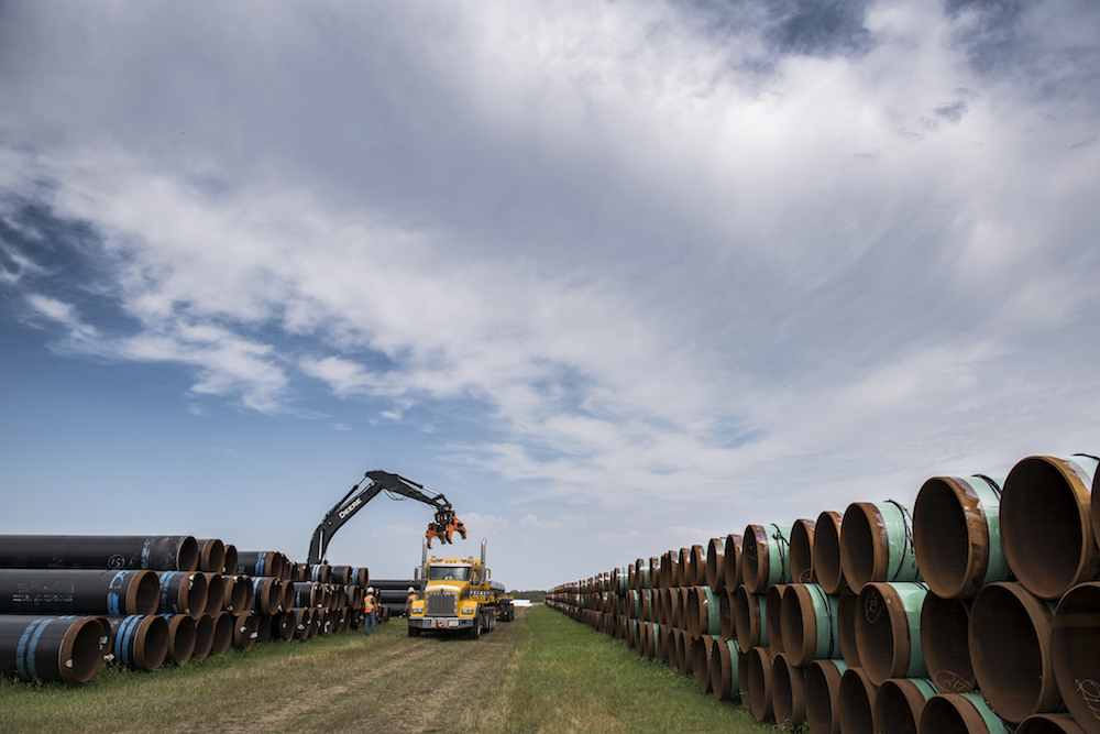 Loading pipe sections onto a truck for Enbridge's Line 3 replacement project