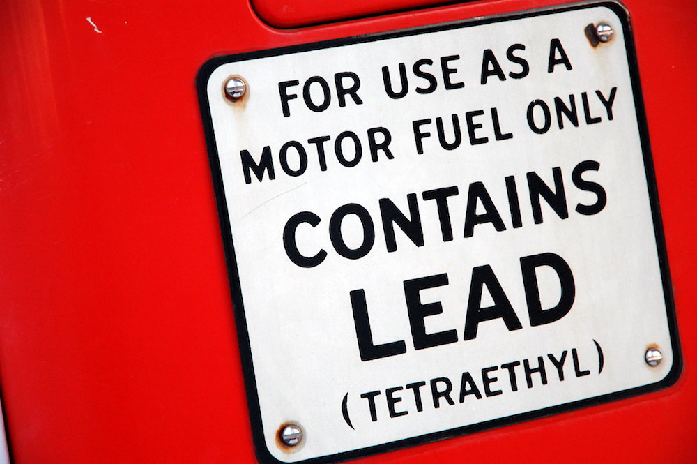 Gas station sign indicating the fuel contains lead