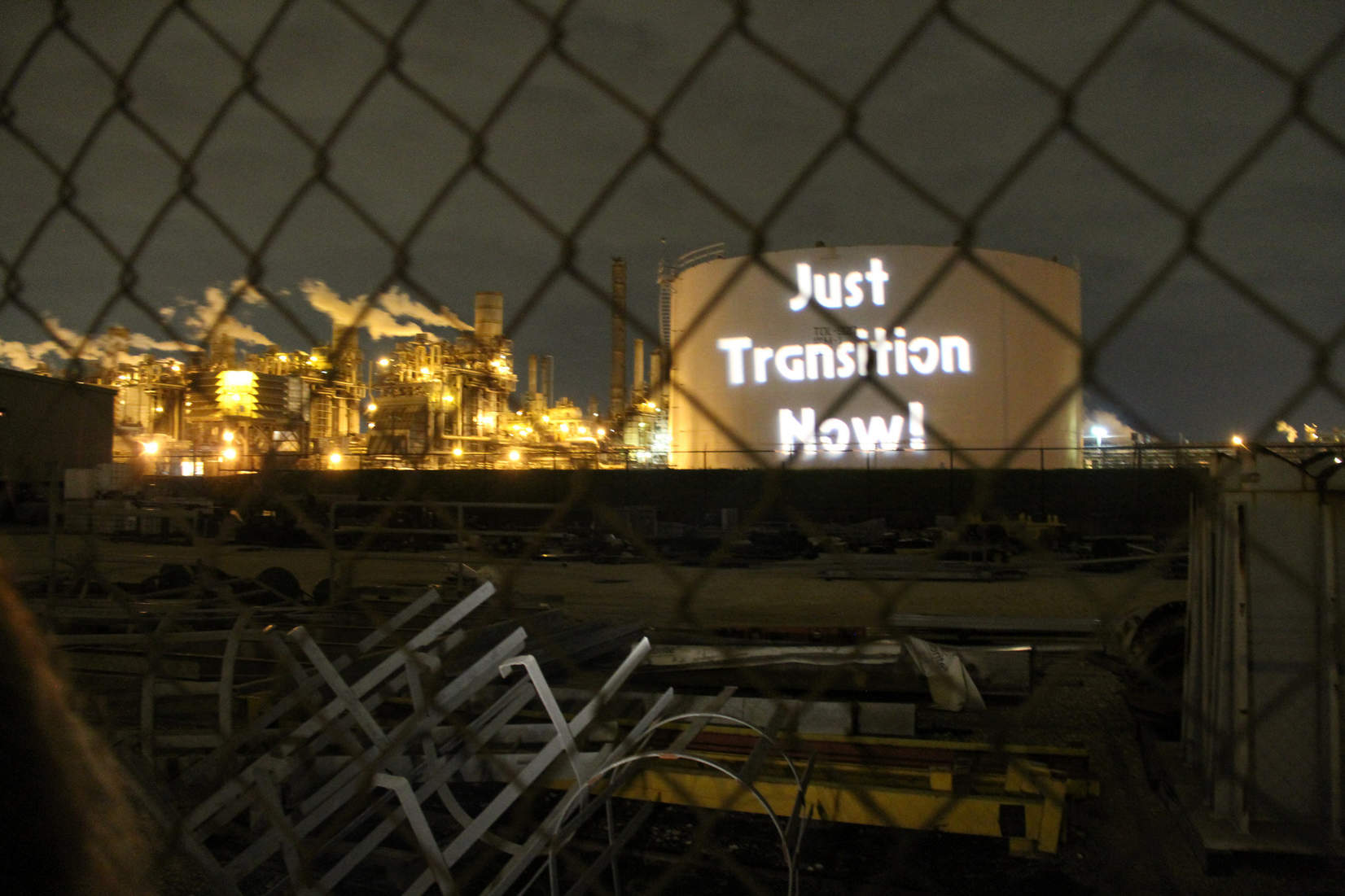 Just Transition projected on Houston petrochemical plant storage tank