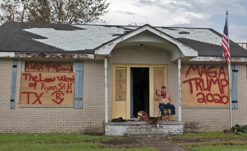 A Trump supporter on the porch of a damaged home in Lake Charles, Louisiana