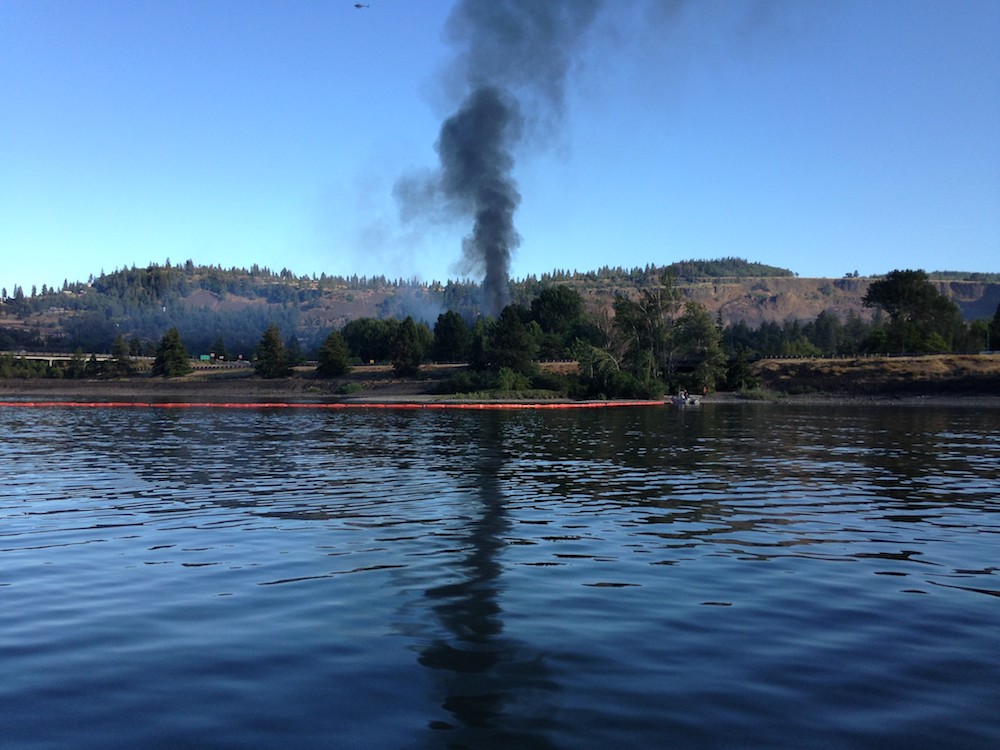 Mosier, Oregon, oil train derailment smoke and oil boom on river