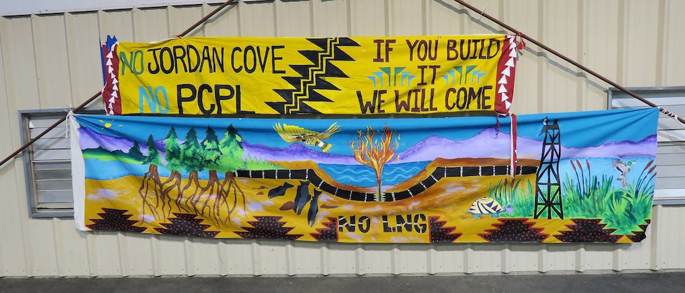 Murals opposing the Jordan Cove LNG terminal and Pacific Connector pipeline hang near the site of the Jackson County Department of State Lands hearing.