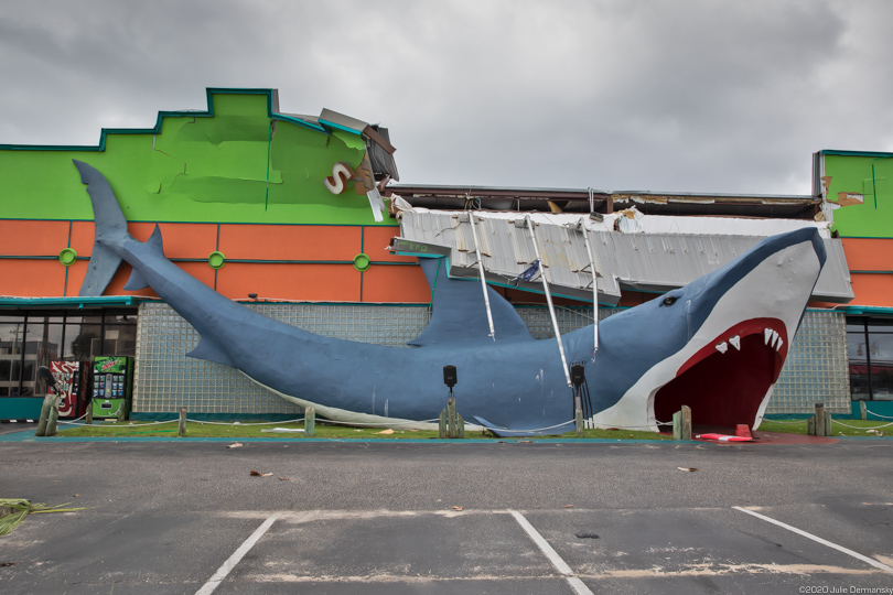 Damaged gift store with giant fake shark in front of it in Gulf Shores, Alabama, following Hurricane Sally.
