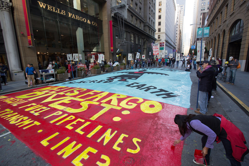 Anti-pipeline divestment street art protest outside Wells Fargo World Headquarters in San Francisco.